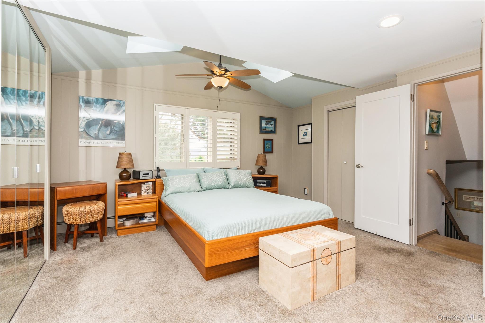 2772 Riverside Avenue Merrick, NY 11566 - Photo 15 of 45 a spacious bedroom with a bed and a chandelier