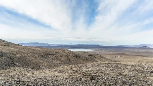 a view of an ocean beach and mountain