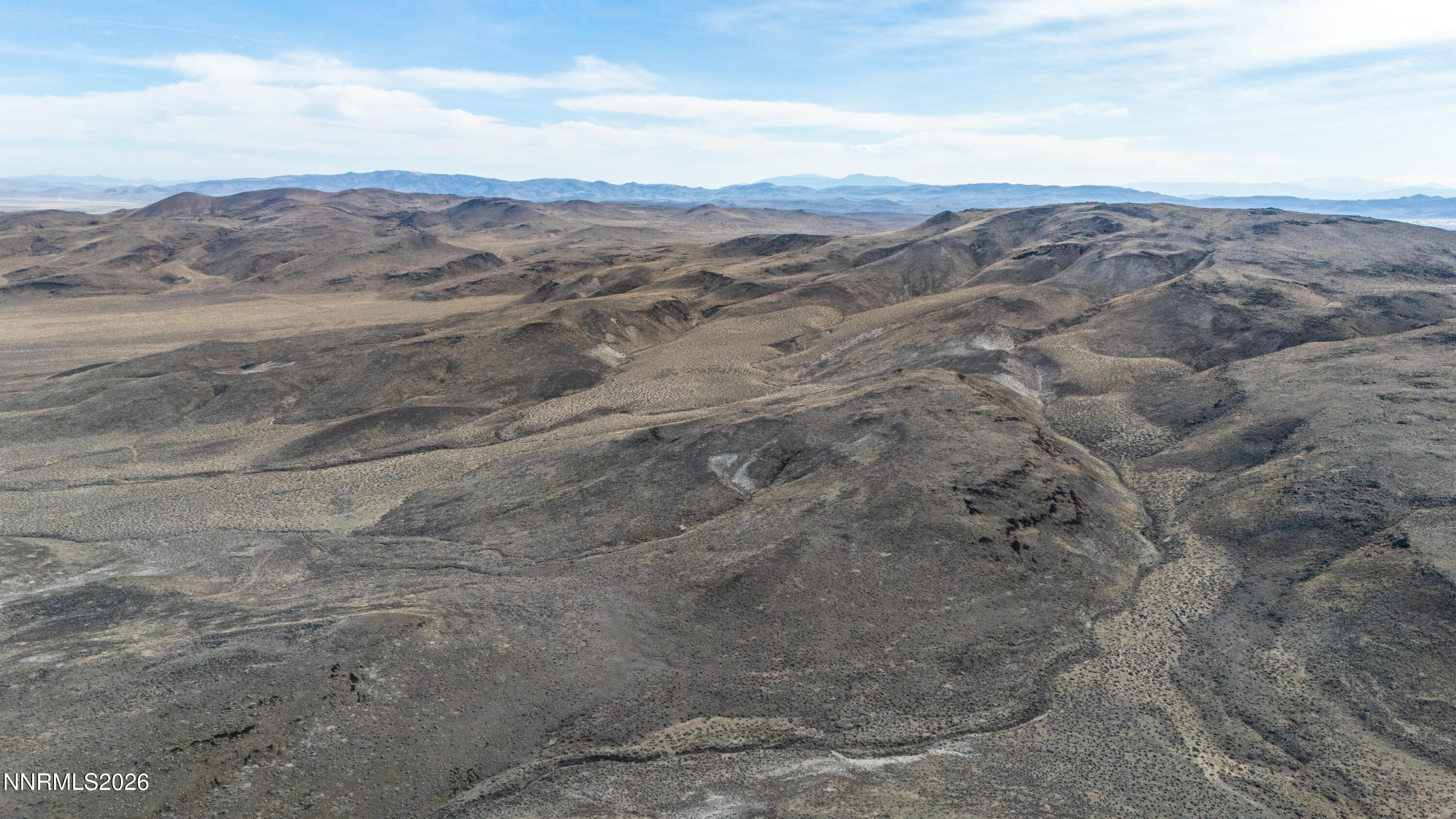 16642 Power Line Road Fallon, NV 89406 - Photo 23 of 54 a view of a dry field with mountains in the background