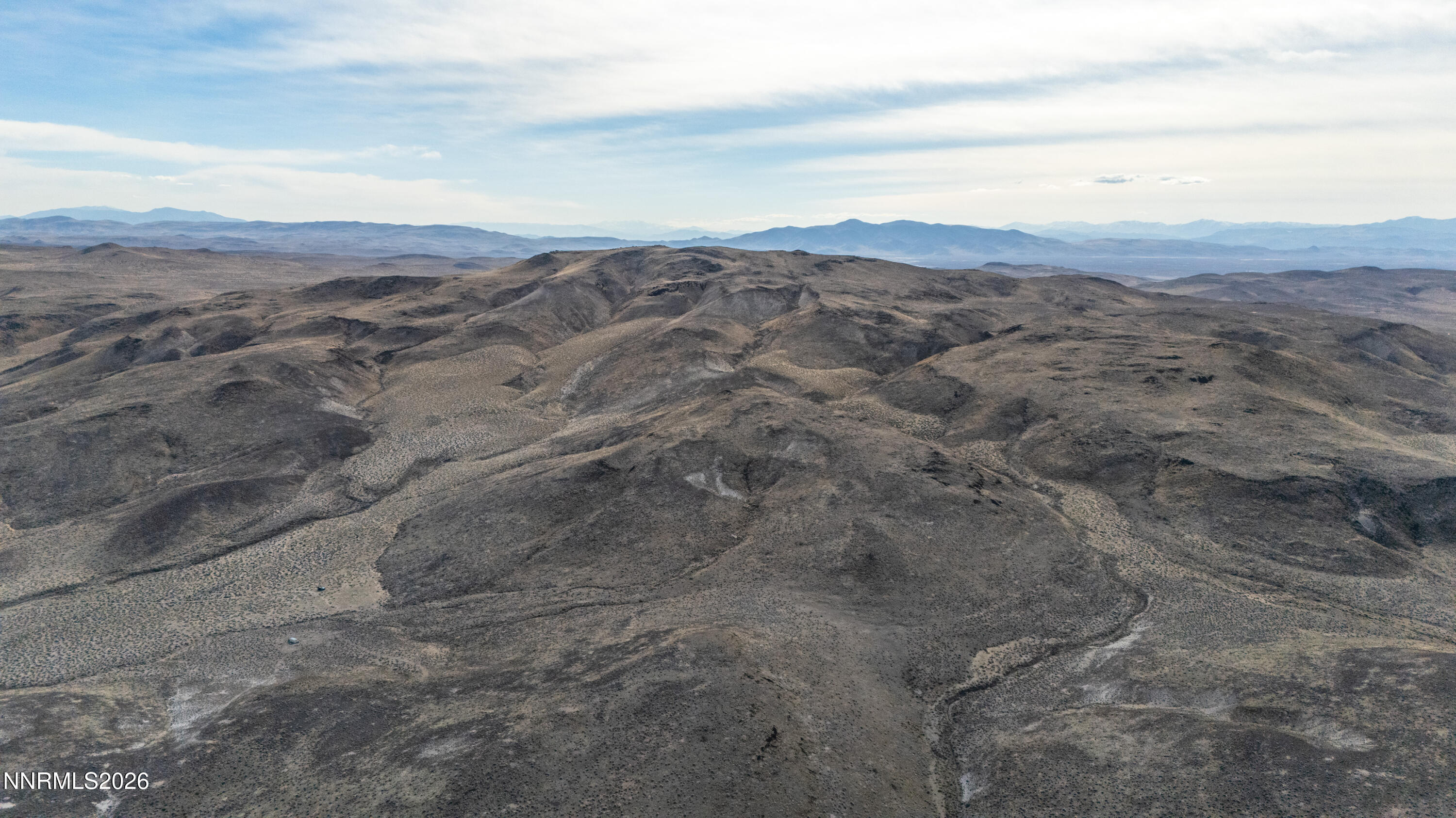 16642 Power Line Road Fallon, NV 89406 - Photo 25 of 54 a view of a dry field with mountains in the background