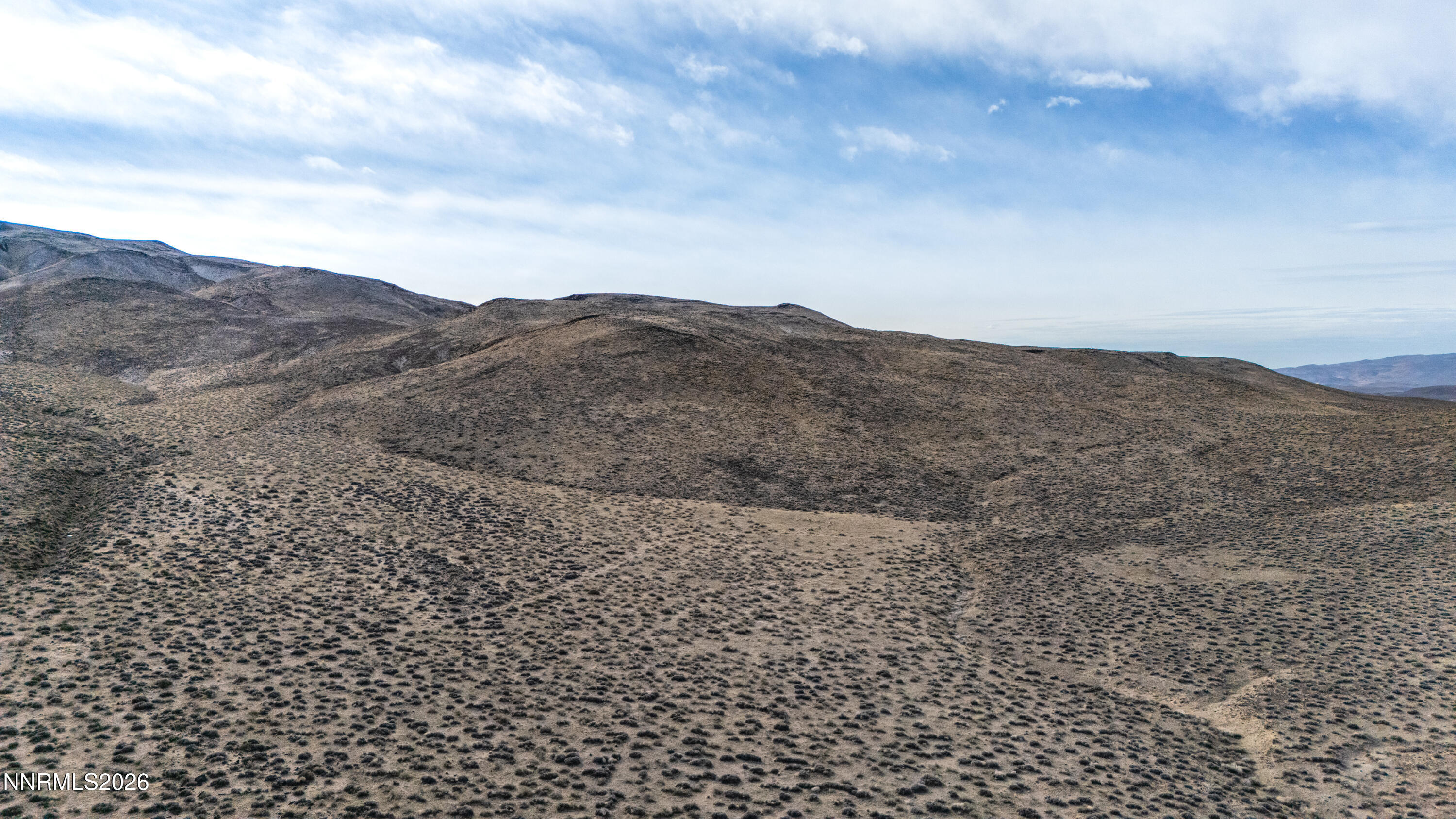 16642 Power Line Road Fallon, NV 89406 - Photo 43 of 54 a view of a dry yard with mountains in the background