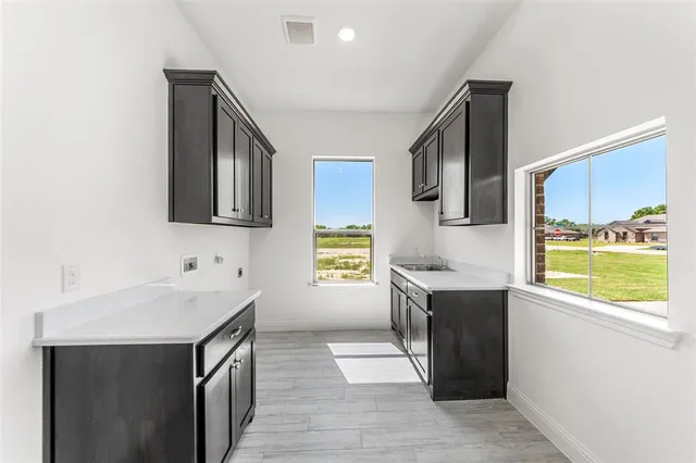 a room with wooden floor and cabinets