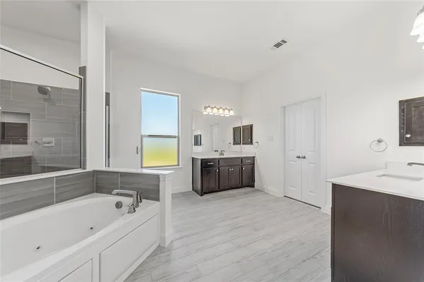 a bathroom with a tub sitting next to a window