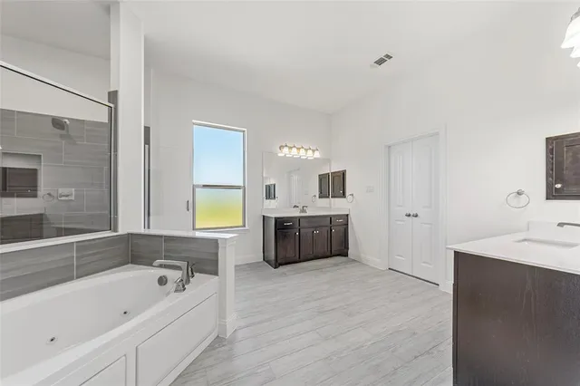 a bathroom with a tub sitting next to a window