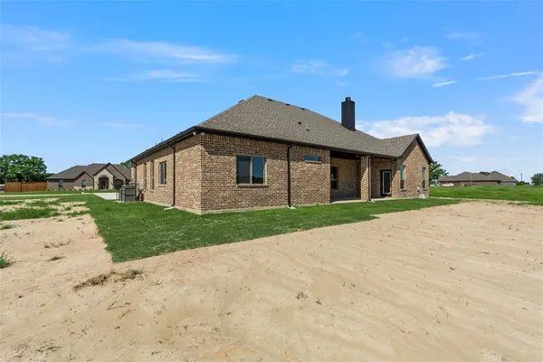 a bathroom with a tub a double vanity sink and mirror