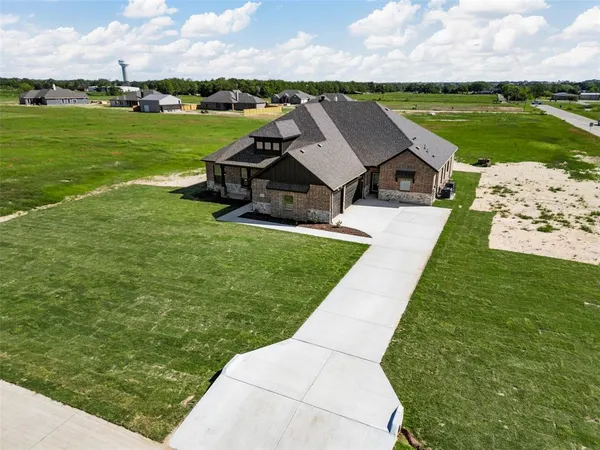 an aerial view of a house with big yard