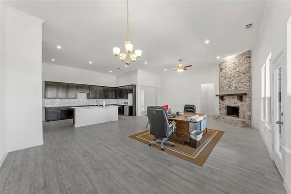 a living room with furniture and kitchen view