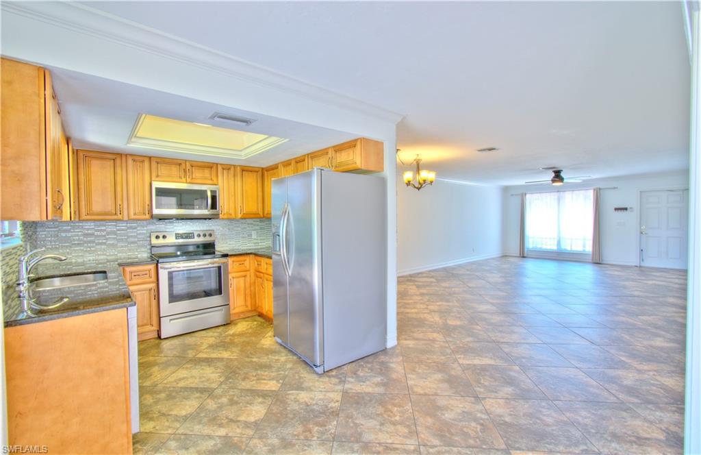 787 Palm View Drive, Unit 3 Naples, FL 34110 - Photo 12 of 27 a view of a kitchen with a sink and a refrigerator