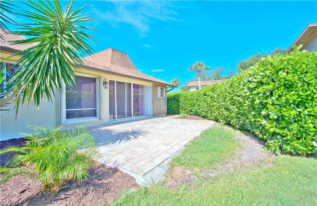 787 Palm View Drive, Unit 3 Naples, FL 34110 - Photo 17 of 27 a front view of a house with a garden