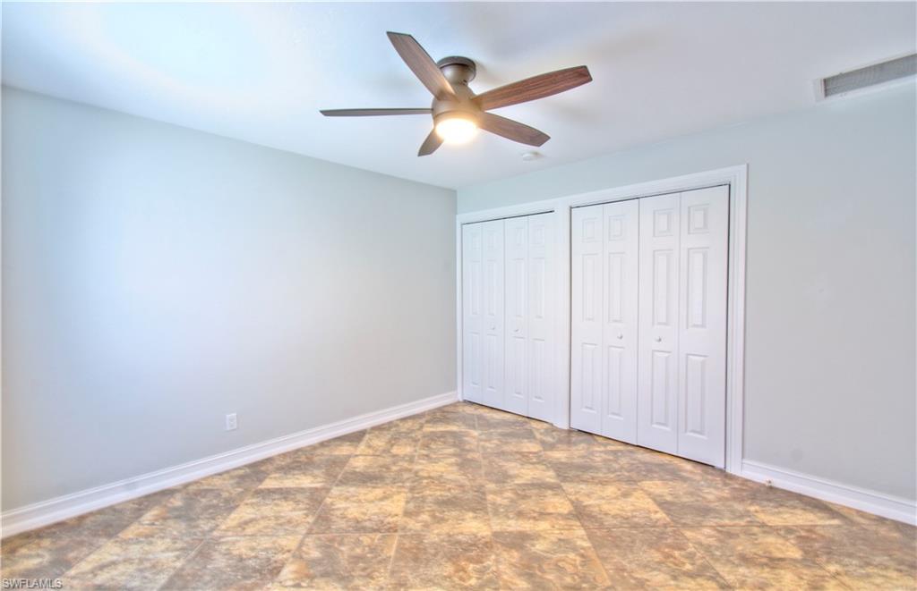 787 Palm View Drive, Unit 3 Naples, FL 34110 - Photo 19 of 27 an empty room with closet and windows