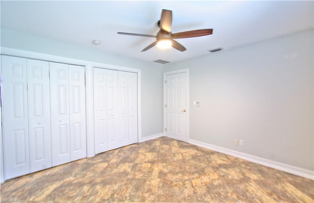787 Palm View Drive, Unit 3 Naples, FL 34110 - Photo 20 of 27 an empty room with a ceiling fan and a window