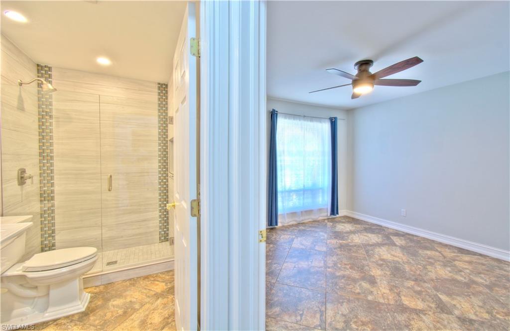 787 Palm View Drive, Unit 3 Naples, FL 34110 - Photo 21 of 27 a bathroom with a granite countertop sink a toilet and shower