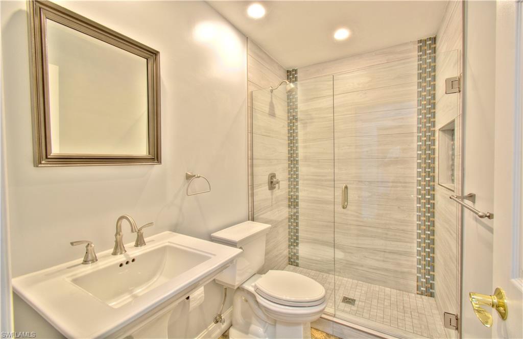 787 Palm View Drive, Unit 3 Naples, FL 34110 - Photo 22 of 27 a bathroom with a sink a toilet and shower