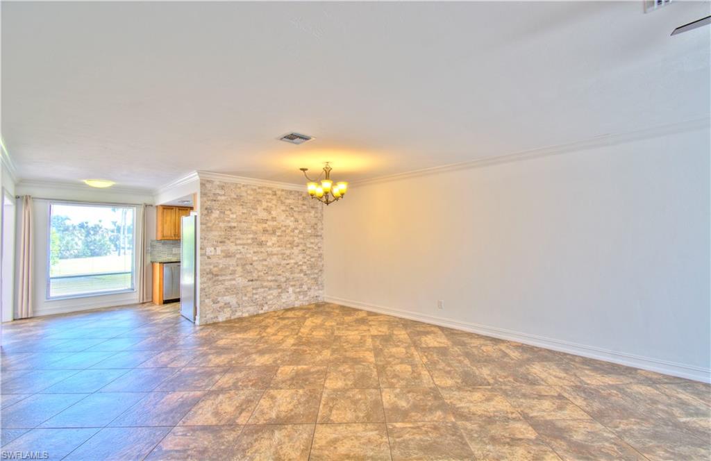 787 Palm View Drive, Unit 3 Naples, FL 34110 - Photo 4 of 27 a view of a big room with wooden floor and natural light