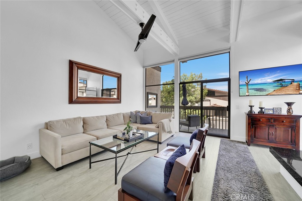 6301 Marina Pacifica Drive Long Beach, CA 90803 - Photo 1 of 39 a living room with furniture and a large window