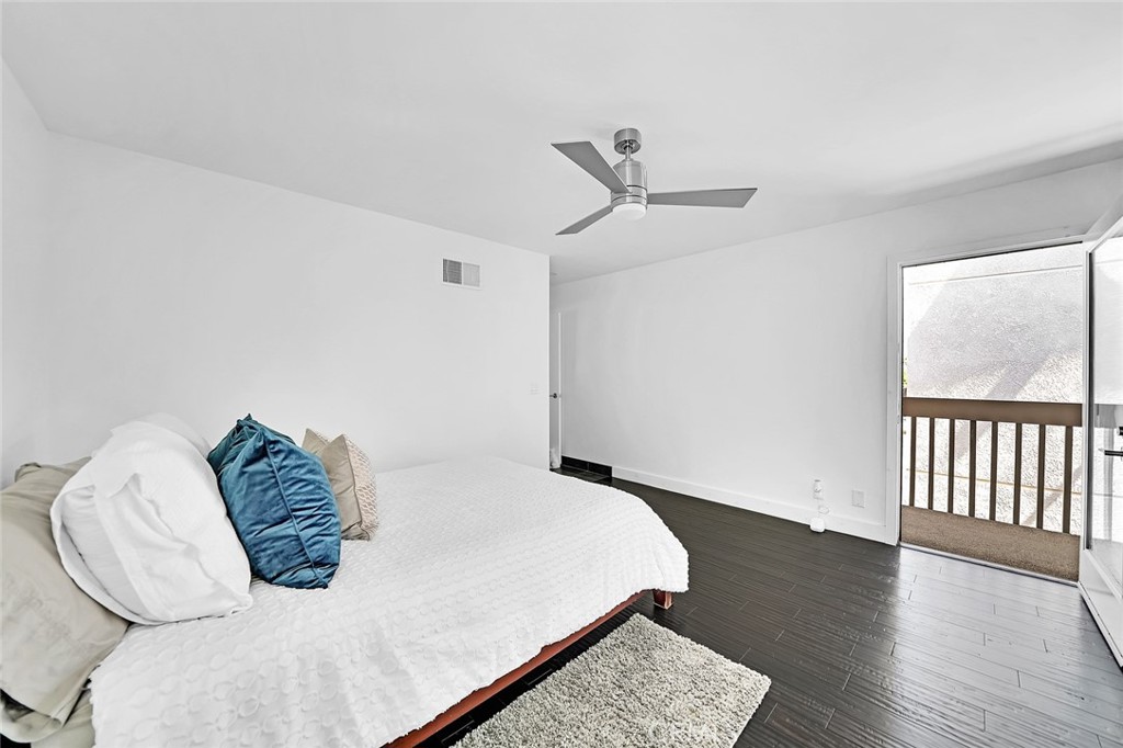 6301 Marina Pacifica Drive Long Beach, CA 90803 - Photo 12 of 39 a bedroom with a bed and wooden floor
