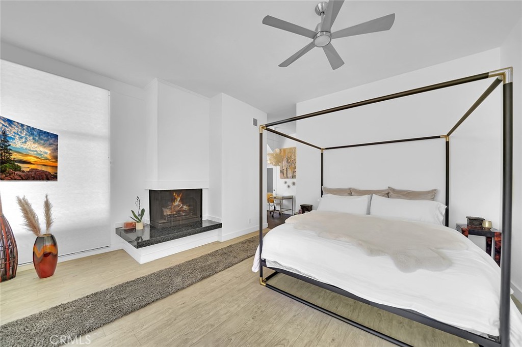 6301 Marina Pacifica Drive Long Beach, CA 90803 - Photo 16 of 39 a bedroom with a bed a couch and a flat screen tv