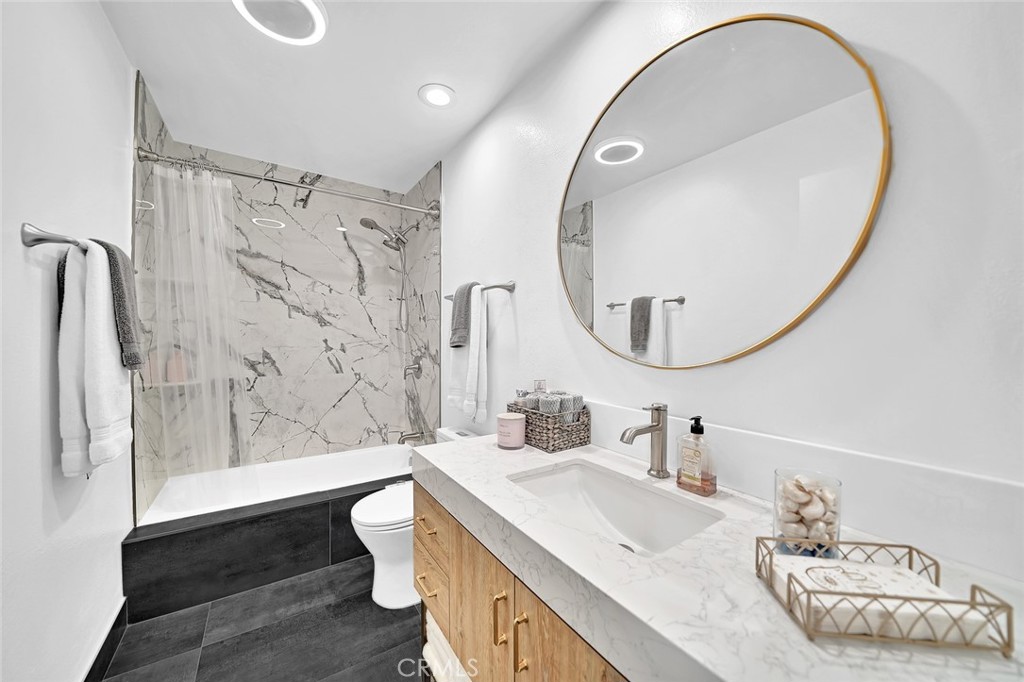 6301 Marina Pacifica Drive Long Beach, CA 90803 - Photo 17 of 39 a bathroom with a sink and a mirror