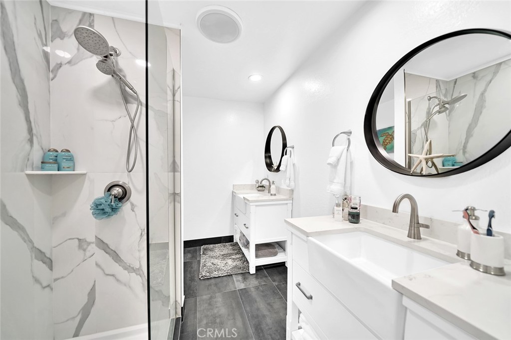 6301 Marina Pacifica Drive Long Beach, CA 90803 - Photo 18 of 39 a bathroom with a sink and a mirror