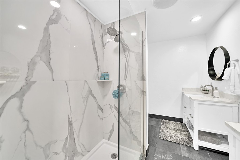 6301 Marina Pacifica Drive Long Beach, CA 90803 - Photo 19 of 39 a bathroom with a sink and mirror