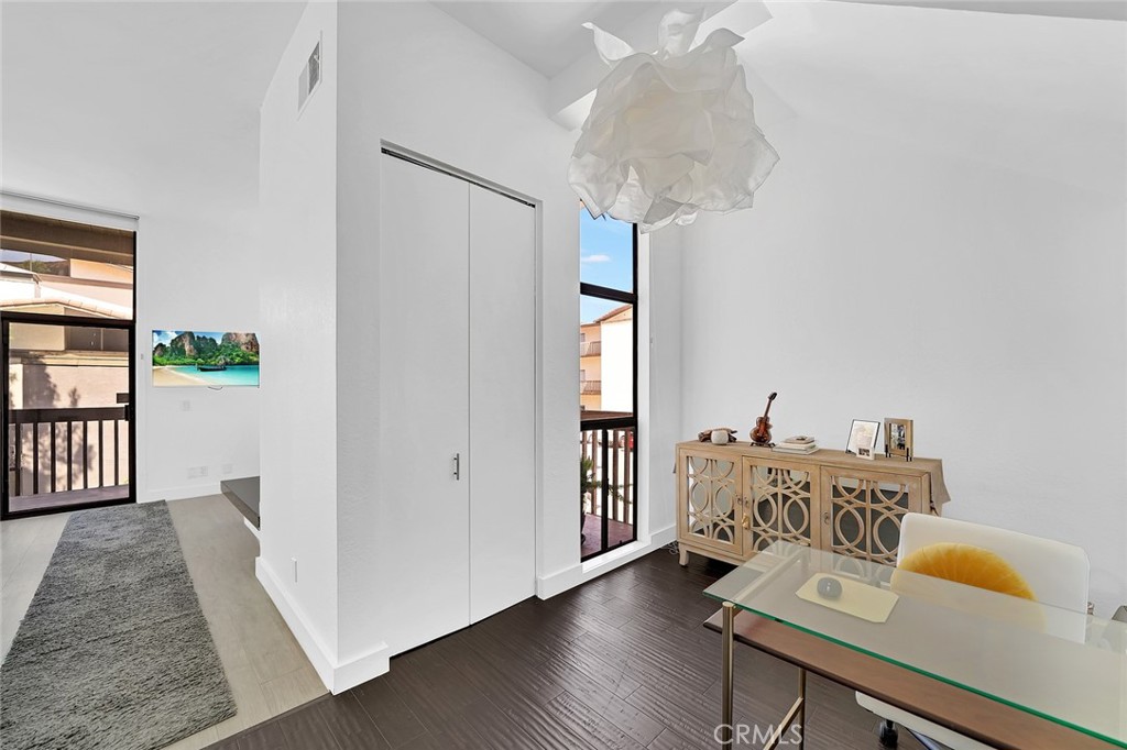 6301 Marina Pacifica Drive Long Beach, CA 90803 - Photo 22 of 39 a view of a workspace with furniture and wooden floor