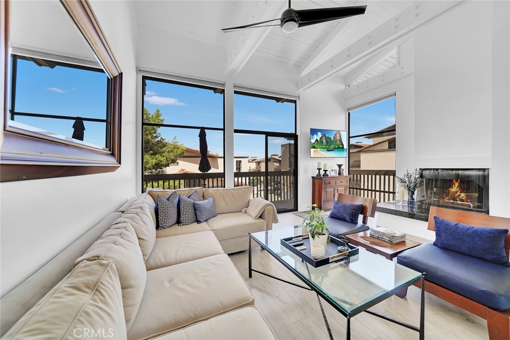 6301 Marina Pacifica Drive Long Beach, CA 90803 - Photo 3 of 39 a living room with furniture a rug potted plant and a large window