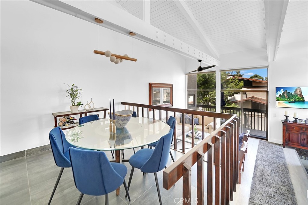 6301 Marina Pacifica Drive Long Beach, CA 90803 - Photo 8 of 39 a dining room with furniture a chandelier and wooden floor