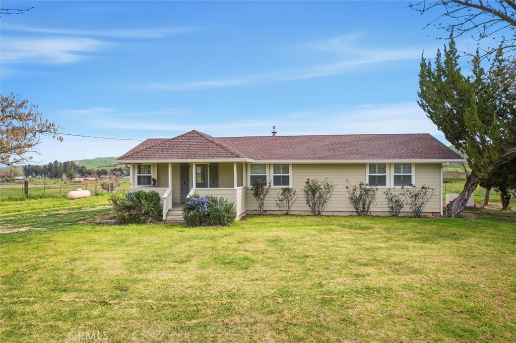 a front view of a house with a big yard