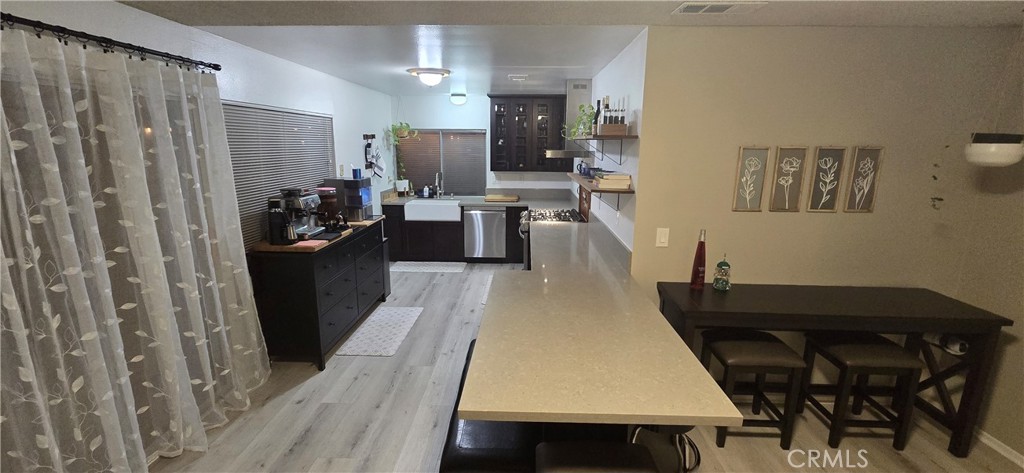 6830 Astoria Drive Riverside, CA 92503 - Photo 7 of 23 a living room with stainless steel appliances furniture a rug and a view