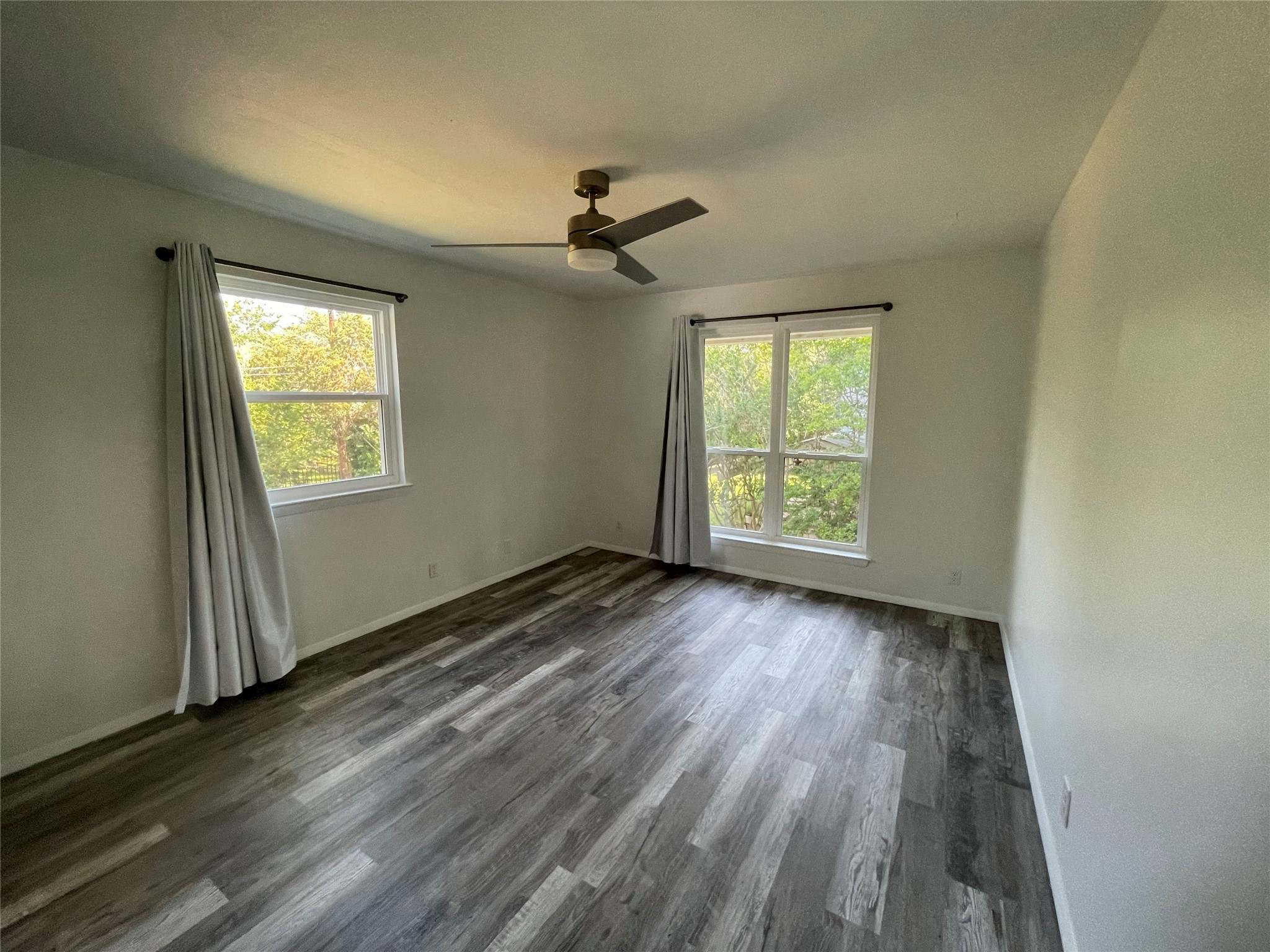 5802 Longhorn Landing Austin, TX 78734 - Photo 31 of 38 Spare room with dark wood-type flooring, plenty of natural light, and ceiling fan