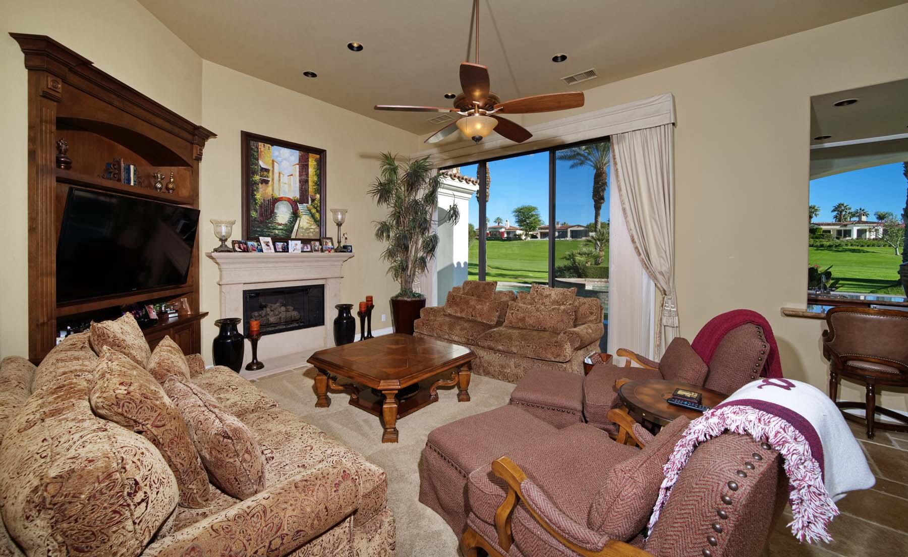 76128 Via Firenze Indian Wells, CA 92210 - Photo 11 of 67 a living room with furniture a flat screen tv and a fireplace