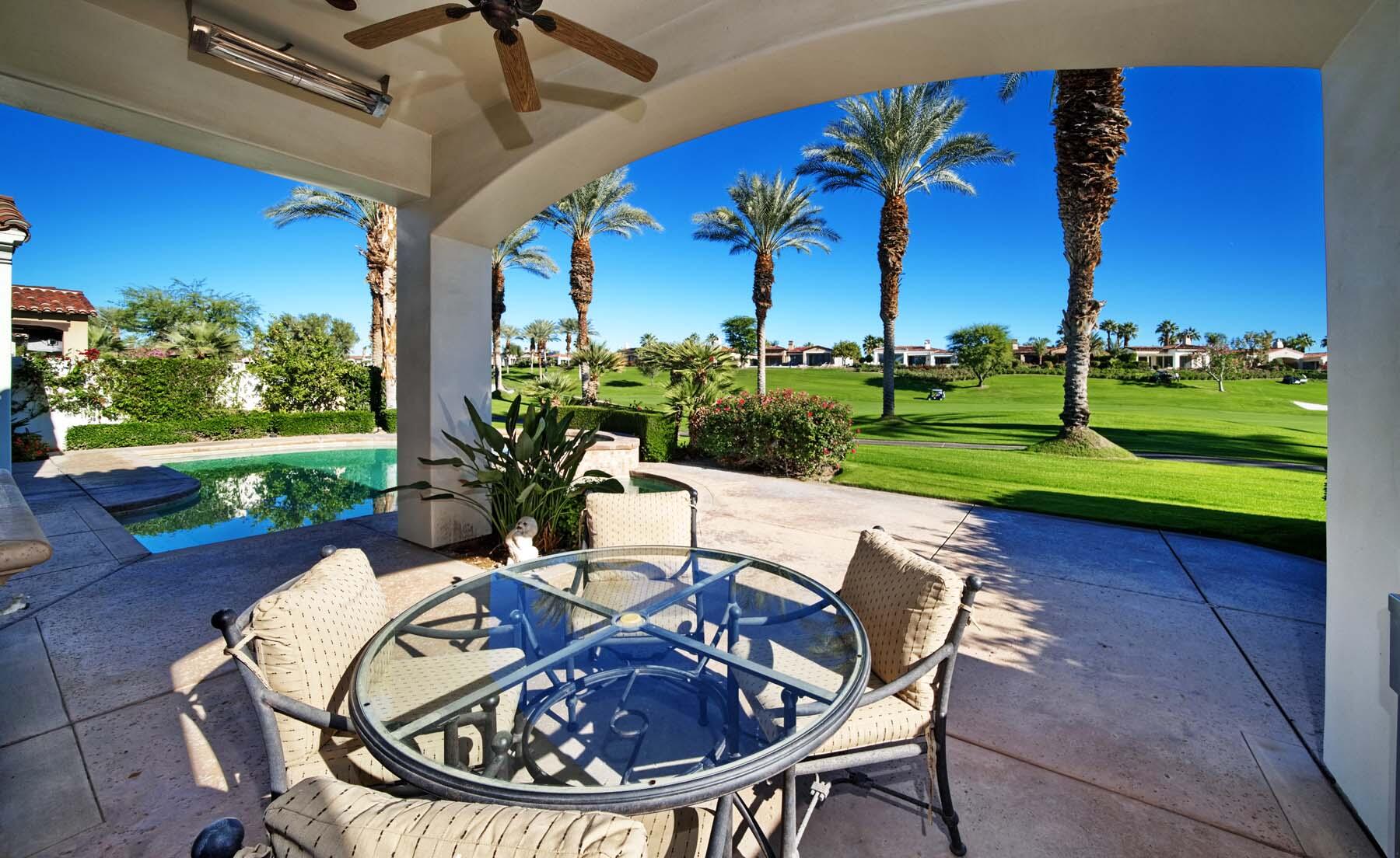 76128 Via Firenze Indian Wells, CA 92210 - Photo 19 of 67 a view of a patio with a table chairs and a backyard