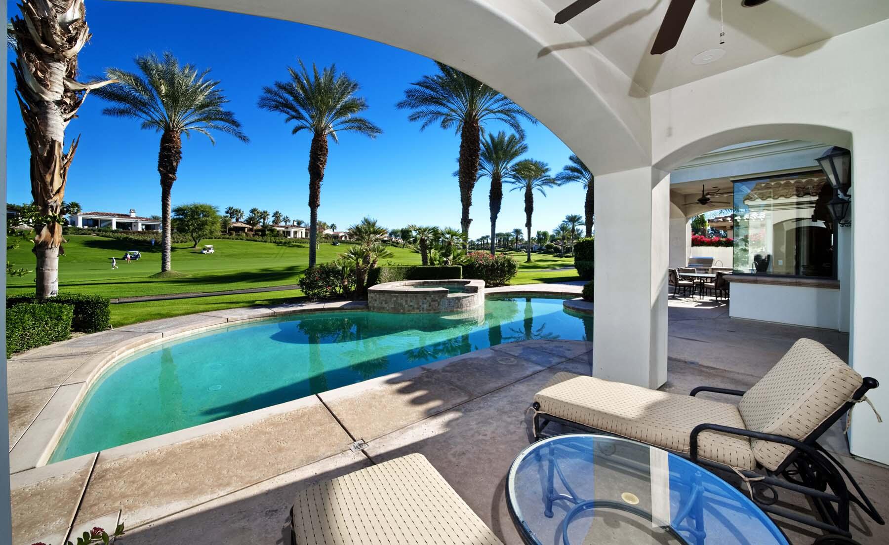 76128 Via Firenze Indian Wells, CA 92210 - Photo 23 of 67 a view of a backyard with couches plants and large trees