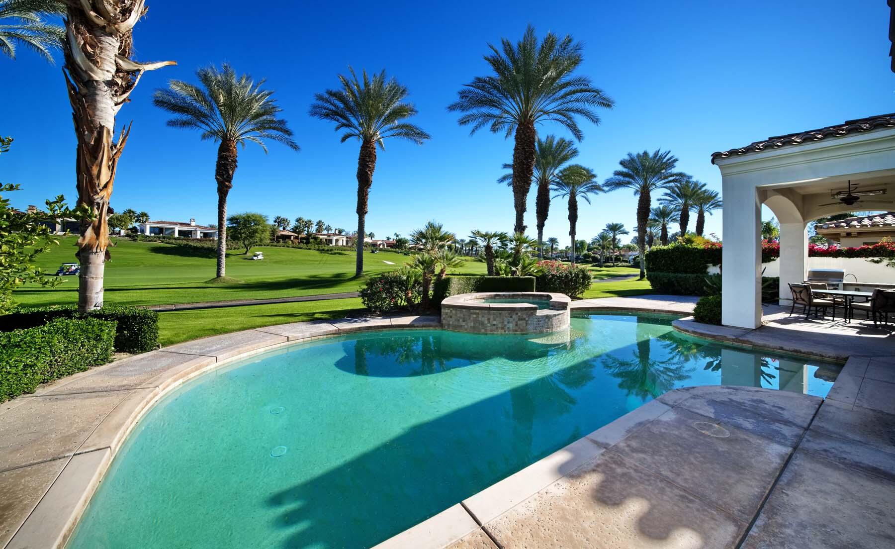 76128 Via Firenze Indian Wells, CA 92210 - Photo 25 of 67 a view of a swimming pool with a garden and patio