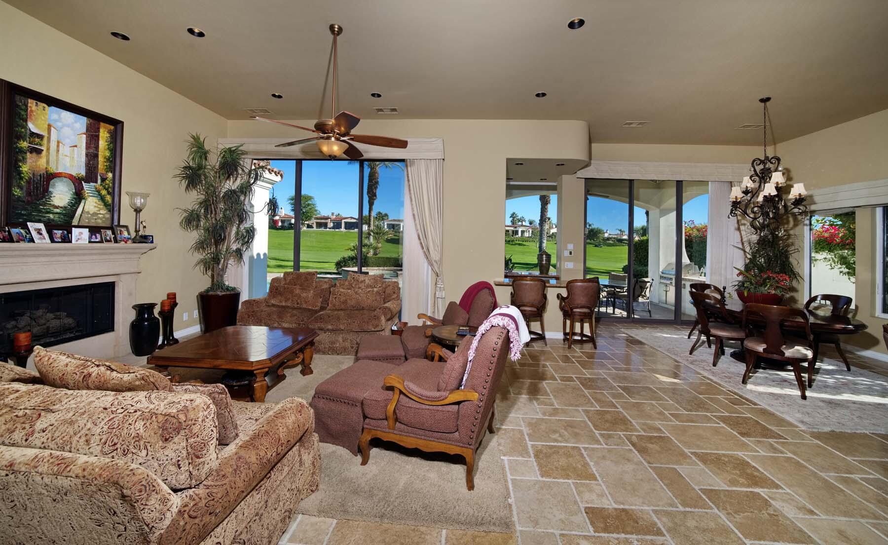76128 Via Firenze Indian Wells, CA 92210 - Photo 9 of 67 a living room with furniture a fireplace and a chandelier