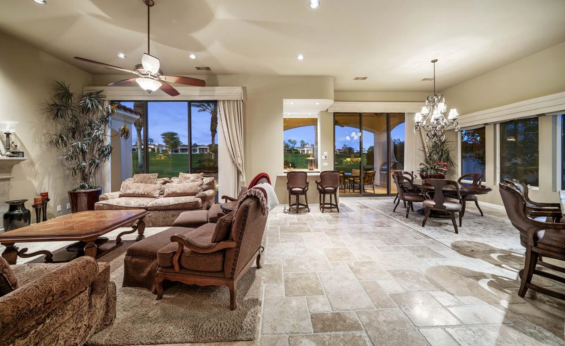 76128 Via Firenze Indian Wells, CA 92210 - Photo 10 of 67 a view of a dining room and livingroom with furniture large windows a chandelier