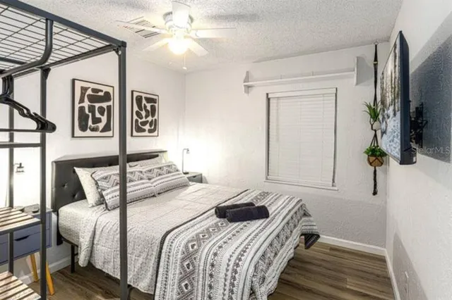 a bedroom with a bed and a flat screen tv
