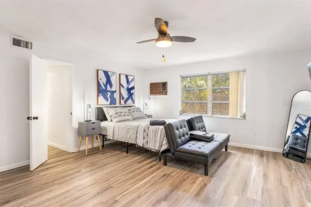 a bed room with a bed and a chair