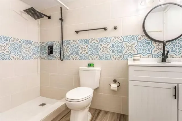 a bathroom with a toilet a sink and a mirror