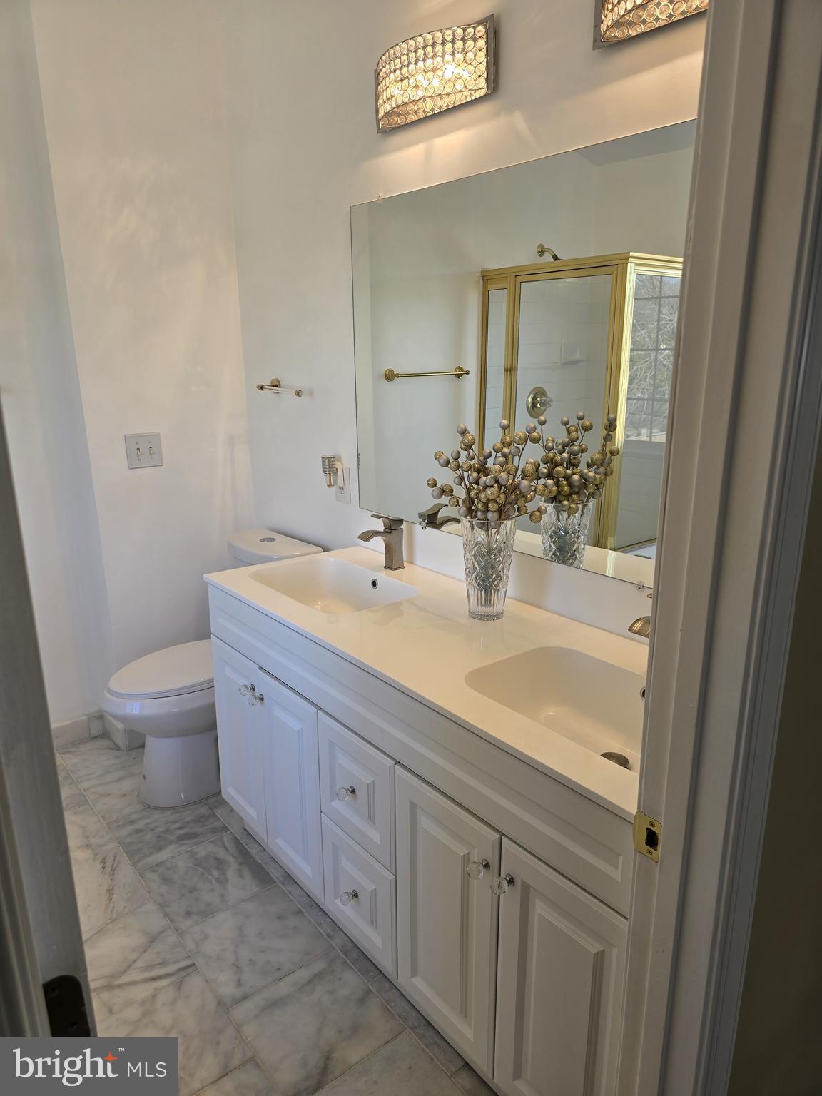 12708 Dunkirk Drive Upper Marlboro, MD 20772 - Photo 11 of 19 a bathroom with a granite countertop sink a toilet and a mirror