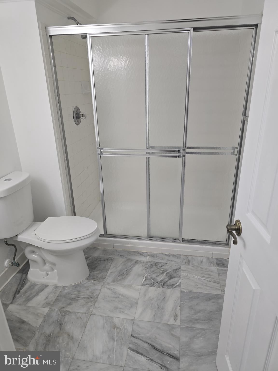 12708 Dunkirk Drive Upper Marlboro, MD 20772 - Photo 18 of 19 a white toilet sitting next to a shower