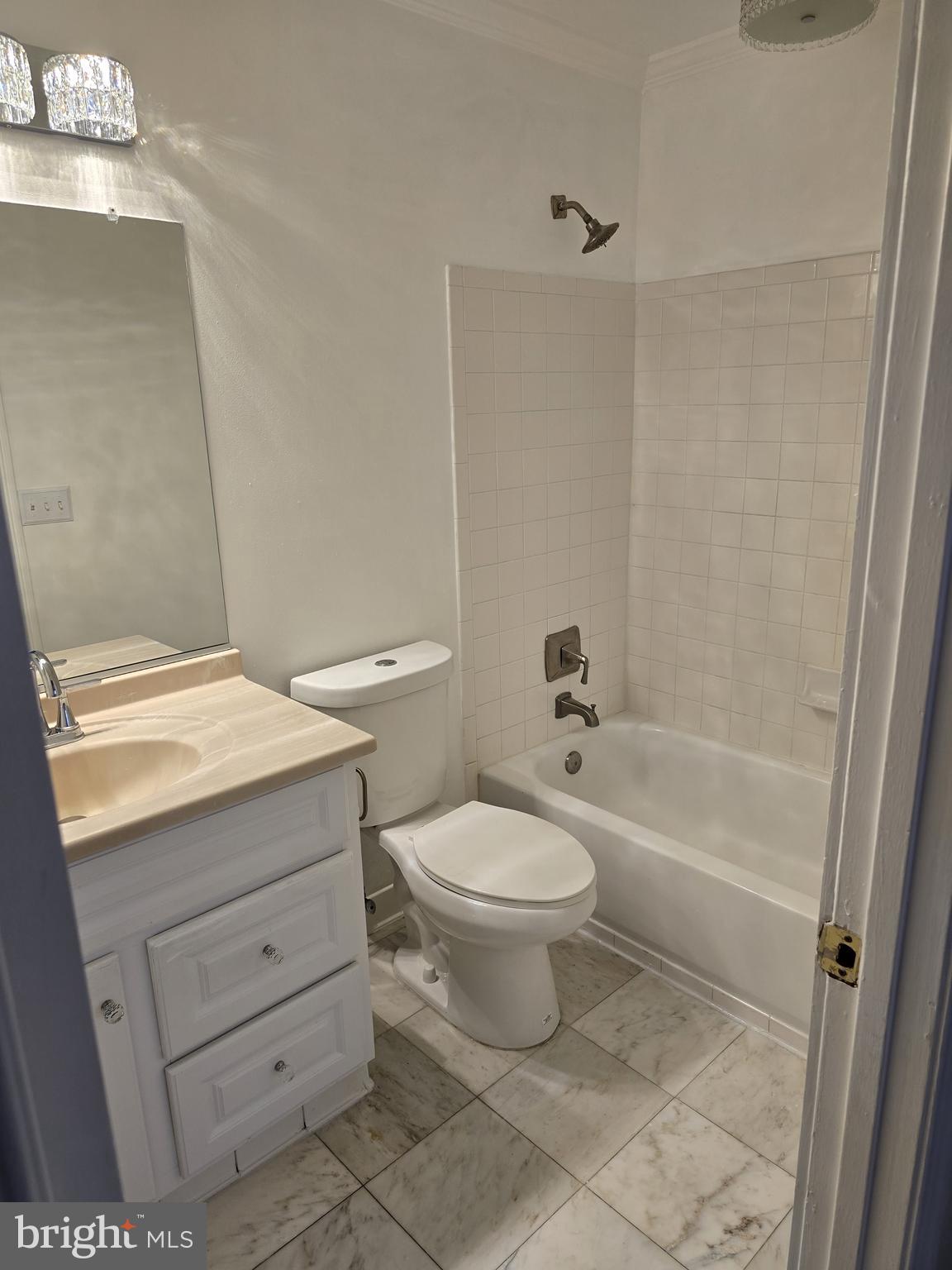 12708 Dunkirk Drive Upper Marlboro, MD 20772 - Photo 4 of 19 a bathroom with a granite countertop toilet a sink and a bathtub