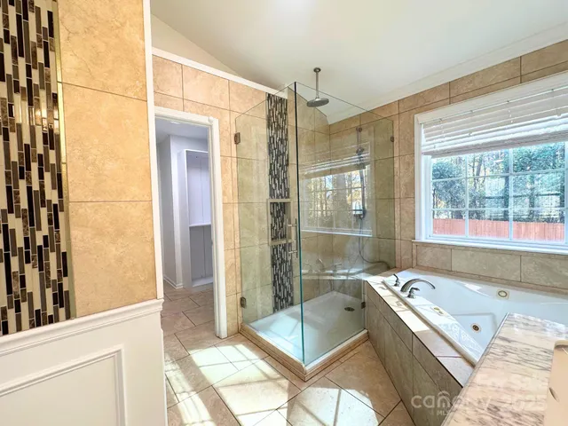 a bathroom with a tub shower and sink