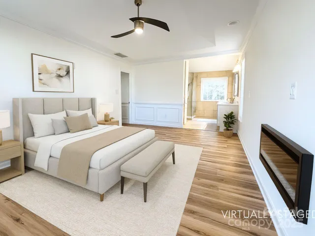 a bedroom with bed and a chandelier