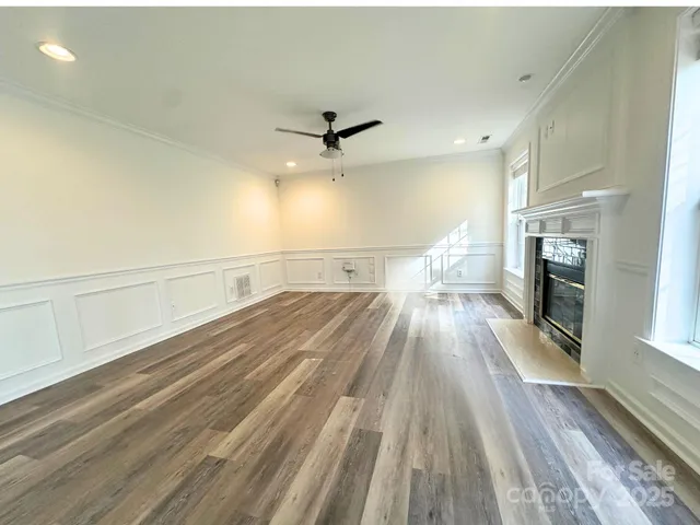 a view of a living room with wooden floor and floors
