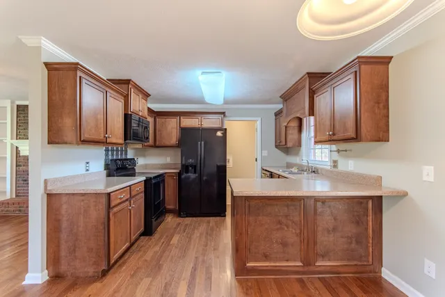 a kitchen with a sink stove and refrigerator