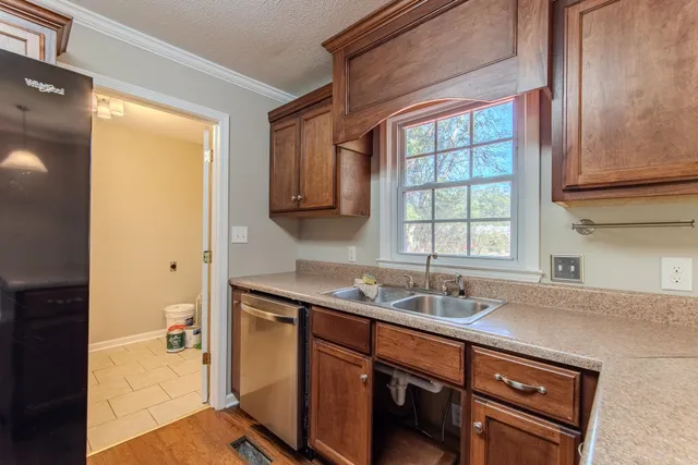 a kitchen with stainless steel appliances granite countertop a sink and a window