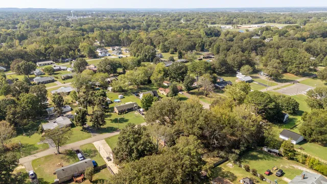an aerial view of residential house with yard and mountain view