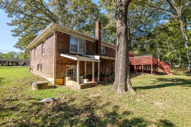 a view of a house with yard and sitting area
