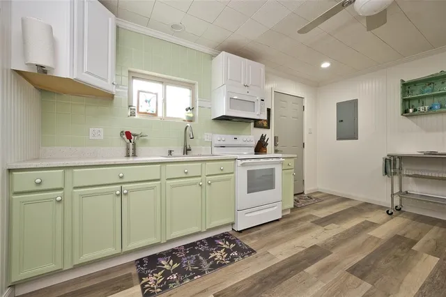 a kitchen with white cabinets and white appliances